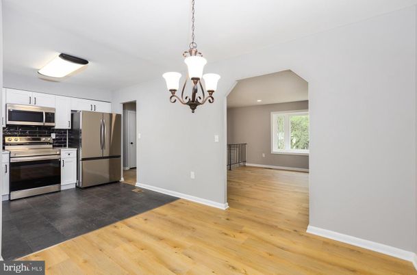 Chandelier, Empty room, Interior, Kitchen, Recessed Lighting, Stainless Steel Appliances, Wood Texture Flooring