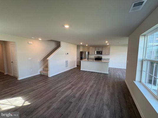 Empty room, Interior, Kitchen, Recessed Lighting, Stainless Steel Appliances, Wood Texture Flooring