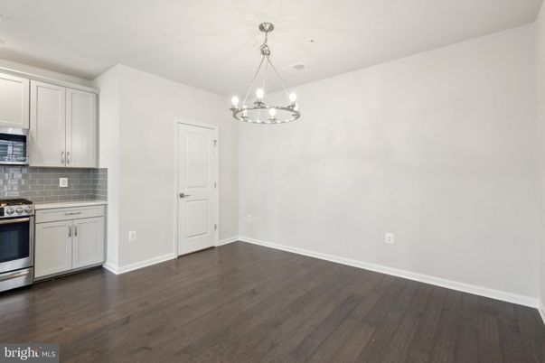 Empty room, Interior, Kitchen, Pendant Lights, Stainless Steel Appliances, Wood Texture Flooring