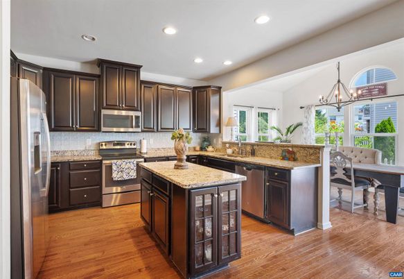 Chandelier, Dining room, Interior, Kitchen, Pendant Lights, Recessed Lighting, Stainless Steel Appliances, Wood Texture Flooring