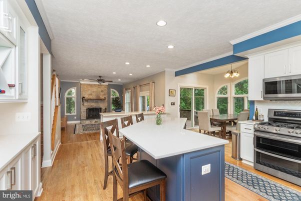 Dining room, Fireplace, Interior, Kitchen, Pendant Lights, Recessed Lighting, Stainless Steel Appliances, Wood Texture Flooring