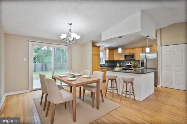 Chandelier, Dining room, Interior, Kitchen, Pendant Lights, Stainless Steel Appliances, Wood Texture Flooring