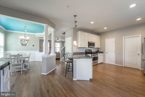 Chandelier, Dining room, Interior, Kitchen, Pendant Lights, Recessed Lighting, Stainless Steel Appliances, Wood Texture Flooring