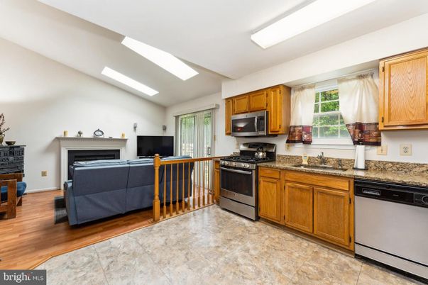 Fireplace, Interior, Kitchen, Stainless Steel Appliances, Wood Texture Flooring