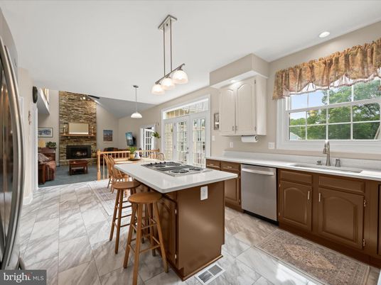 Fireplace, Interior, Kitchen, Marble, Pendant Lights, Recessed Lighting, Stainless Steel Appliances, Stone Walls