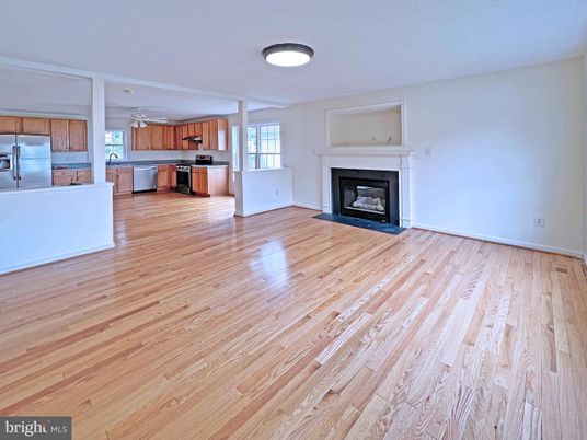 Empty room, Fireplace, Interior, Kitchen, Stainless Steel Appliances, Wood Texture Flooring