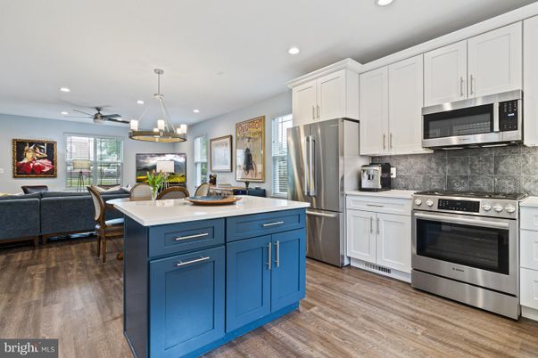 Chandelier, Dining room, Interior, Kitchen, Pendant Lights, Recessed Lighting, Stainless Steel Appliances, Wood Texture Flooring