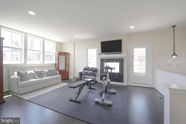 Fireplace, Fitness Equipment, Interior, Pendant Lights, Recessed Lighting, Wood Texture Flooring