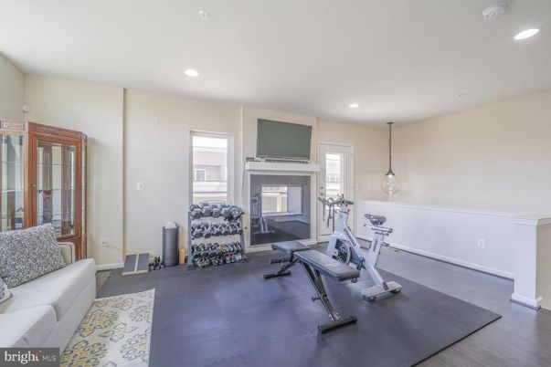 Fireplace, Fitness Equipment, Interior, Pendant Lights, Recessed Lighting, Wood Texture Flooring