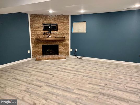 Empty room, Fireplace, Interior, Recessed Lighting, Stone Walls, Wood Texture Flooring
