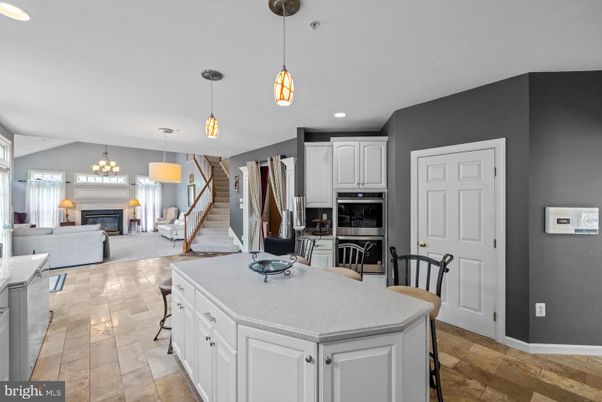 Chandelier, Fireplace, Interior, Kitchen, Living room, Pendant Lights, Recessed Lighting, Stainless Steel Appliances