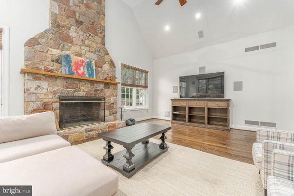 Fireplace, Interior, Living room, Recessed Lighting, Stone Walls, Wood Texture Flooring