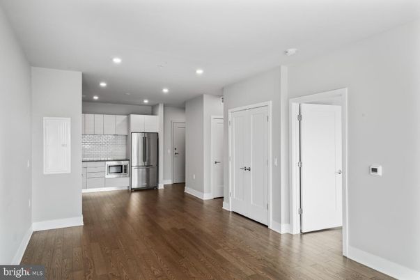 Empty room, Interior, Kitchen, Recessed Lighting, Stainless Steel Appliances, Wood Texture Flooring