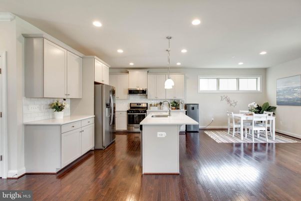 Dining room, Interior, Kitchen, Pendant Lights, Recessed Lighting, Stainless Steel Appliances, Wood Texture Flooring