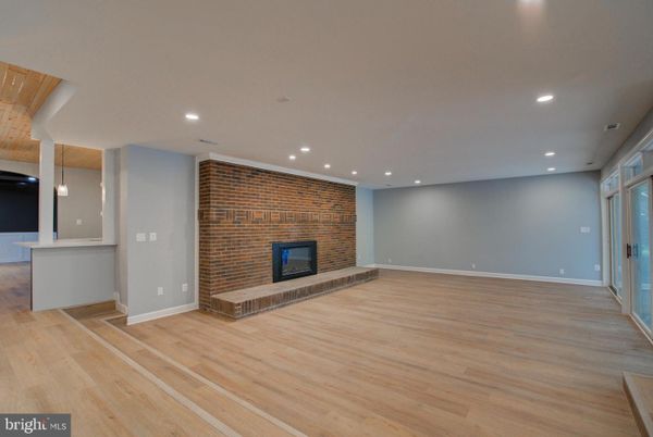 Empty room, Fireplace, Interior, Recessed Lighting, Stone Walls, Wood Texture Flooring
