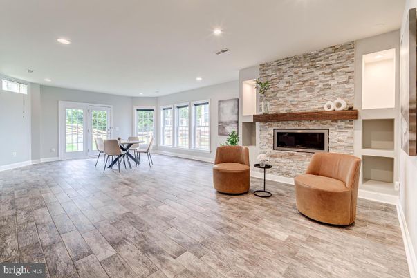 Dining room, Fireplace, Interior, Recessed Lighting, Stone Walls, Wood Texture Flooring