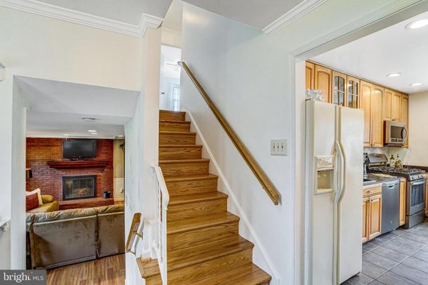 Fireplace, Interior, Kitchen, Recessed Lighting, Stainless Steel Appliances, Stone Walls, Wood Texture Flooring