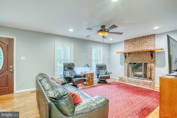 Fireplace, Interior, Living room, Recessed Lighting, Stone Walls, Wood Texture Flooring