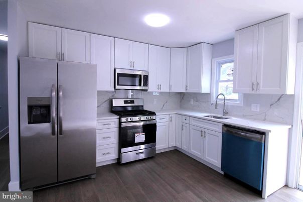 Interior, Kitchen, Marble Walls, Recessed Lighting, Stainless Steel Appliances, Wood Texture Flooring
