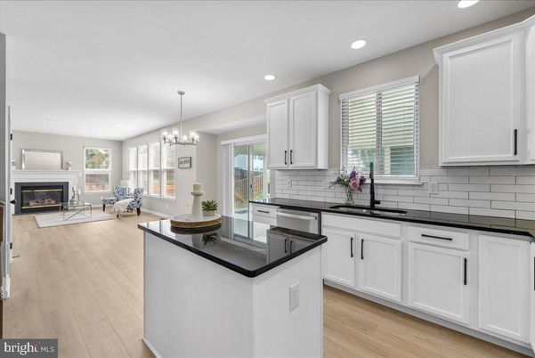 Chandelier, Fireplace, Interior, Kitchen, Living room, Recessed Lighting, Wood Texture Flooring