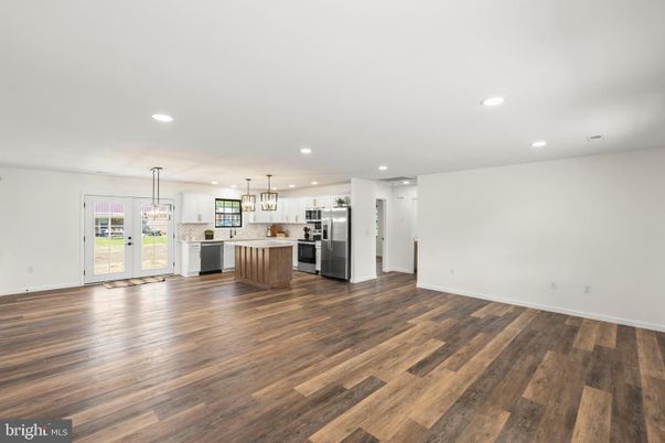 Empty room, Interior, Kitchen, Pendant Lights, Recessed Lighting, Stainless Steel Appliances, Wood Texture Flooring