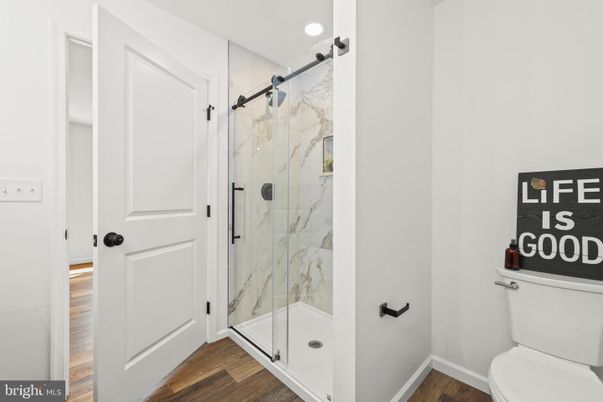 Bathroom, Glass Shower, Interior, Marble Walls, Recessed Lighting, Wood Texture Flooring
