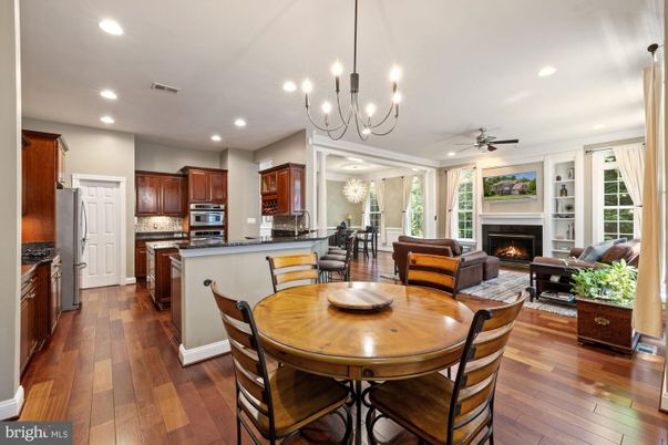 Chandelier, Dining room, Fireplace, Interior, Kitchen, Living room, Recessed Lighting, Stainless Steel Appliances, Wood Texture Flooring