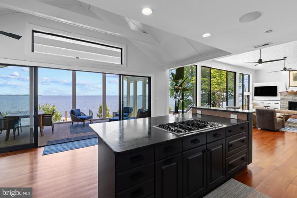 Dining room, Fireplace, Interior, Kitchen, Living room, Recessed Lighting, Water, Wood Texture Flooring