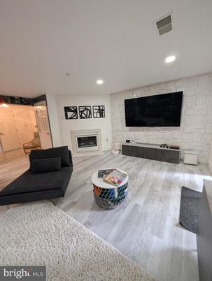 Fireplace, Interior, Living room, Recessed Lighting, Stone Walls, Wood Texture Flooring