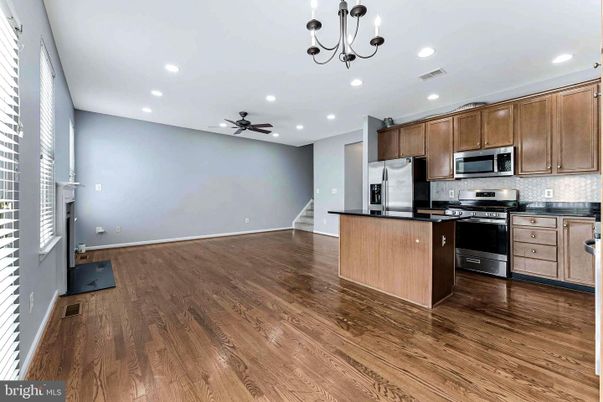 Chandelier, Empty room, Interior, Kitchen, Recessed Lighting, Stainless Steel Appliances, Wood Texture Flooring