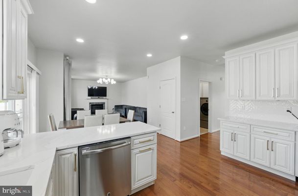 Dining room, Fireplace, Interior, Kitchen, Recessed Lighting, Stainless Steel Appliances, Wood Texture Flooring