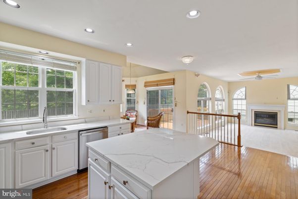 Dining room, Fireplace, Interior, Kitchen, Recessed Lighting, Stainless Steel Appliances, Wood Texture Flooring
