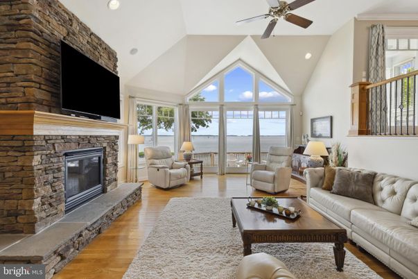 Fireplace, Interior, Living room, Recessed Lighting, Stone Walls, Water, Wood Texture Flooring