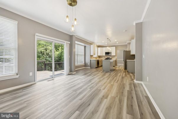 Empty room, Interior, Kitchen, Pendant Lights, Recessed Lighting, Stainless Steel Appliances, Wood Texture Flooring