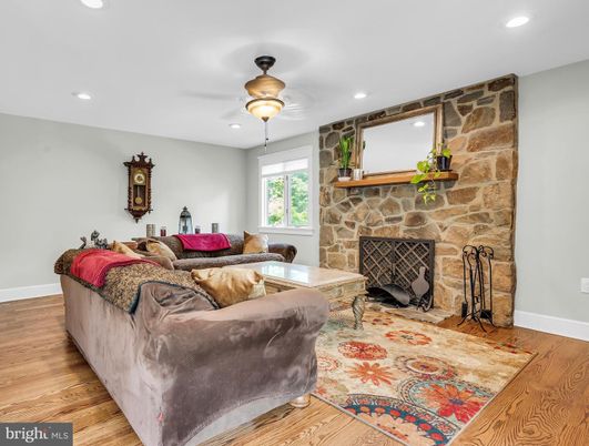Fireplace, Interior, Living room, Recessed Lighting, Stone Walls, Wood Texture Flooring