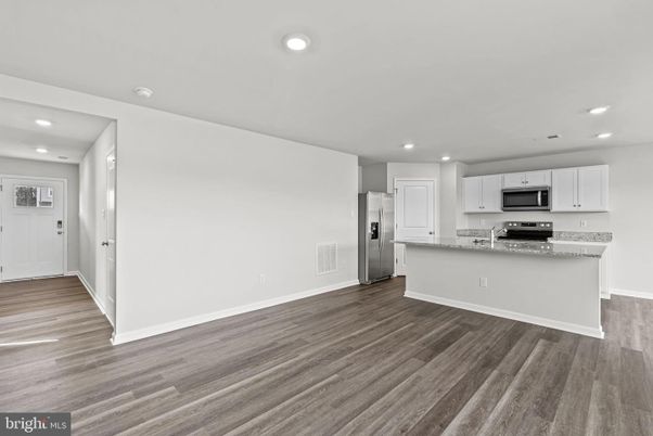 Empty room, Interior, Kitchen, Recessed Lighting, Stainless Steel Appliances, Wood Texture Flooring