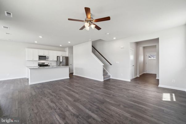 Empty room, Interior, Kitchen, Recessed Lighting, Stainless Steel Appliances, Wood Texture Flooring