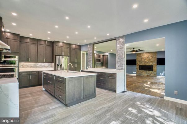 Fireplace, Interior, Kitchen, Recessed Lighting, Stainless Steel Appliances, Stone Walls, Wood Texture Flooring