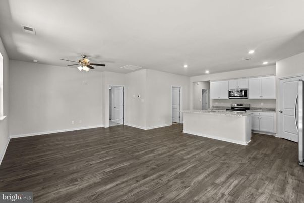 Empty room, Interior, Kitchen, Recessed Lighting, Stainless Steel Appliances, Wood Texture Flooring