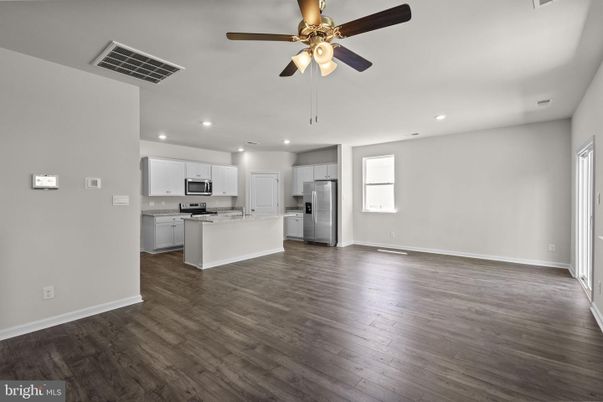 Empty room, Interior, Kitchen, Recessed Lighting, Stainless Steel Appliances, Wood Texture Flooring