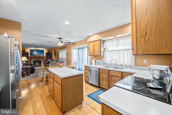 Dining room, Fireplace, Interior, Kitchen, Recessed Lighting, Wood Texture Flooring