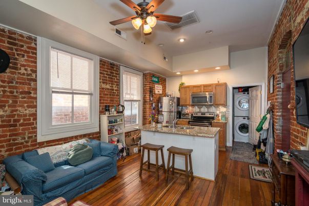 Interior, Kitchen, Recessed Lighting, Stainless Steel Appliances, Stone Walls, Washer, Wood Texture Flooring