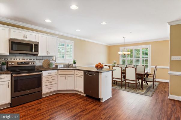 Chandelier, Dining room, Interior, Kitchen, Recessed Lighting, Stainless Steel Appliances, Wood Texture Flooring