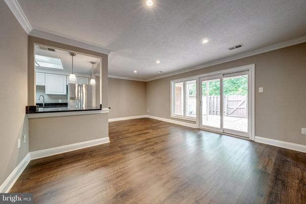 Empty room, Interior, Kitchen, Pendant Lights, Recessed Lighting, Stainless Steel Appliances, Wood Texture Flooring