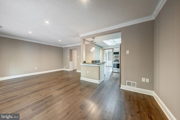 Empty room, Interior, Kitchen, Pendant Lights, Recessed Lighting, Stainless Steel Appliances, Wood Texture Flooring