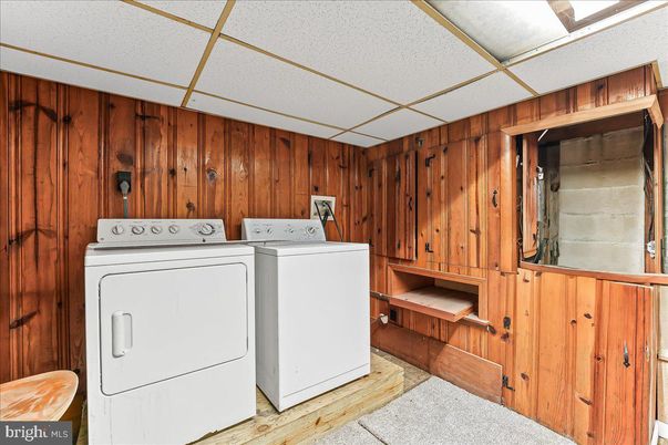 Interior, Utility Closets, Washer, Wood Texture Flooring, Wooden Walls