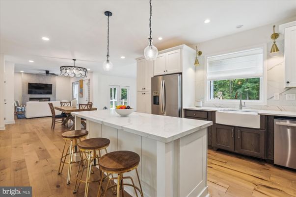 Chandelier, Dining room, Fireplace, Interior, Kitchen, Pendant Lights, Recessed Lighting, Stainless Steel Appliances, Wood Texture Flooring