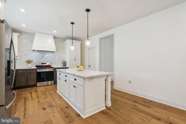 Interior, Kitchen, Marble Walls, Pendant Lights, Recessed Lighting, Stainless Steel Appliances, Wood Texture Flooring