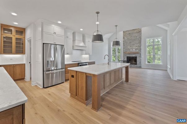 Fireplace, Interior, Kitchen, Pendant Lights, Recessed Lighting, Stainless Steel Appliances, Stone Walls, Wood Texture Flooring