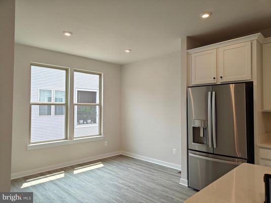 Empty room, Interior, Kitchen, Recessed Lighting, Stainless Steel Appliances, Wood Texture Flooring